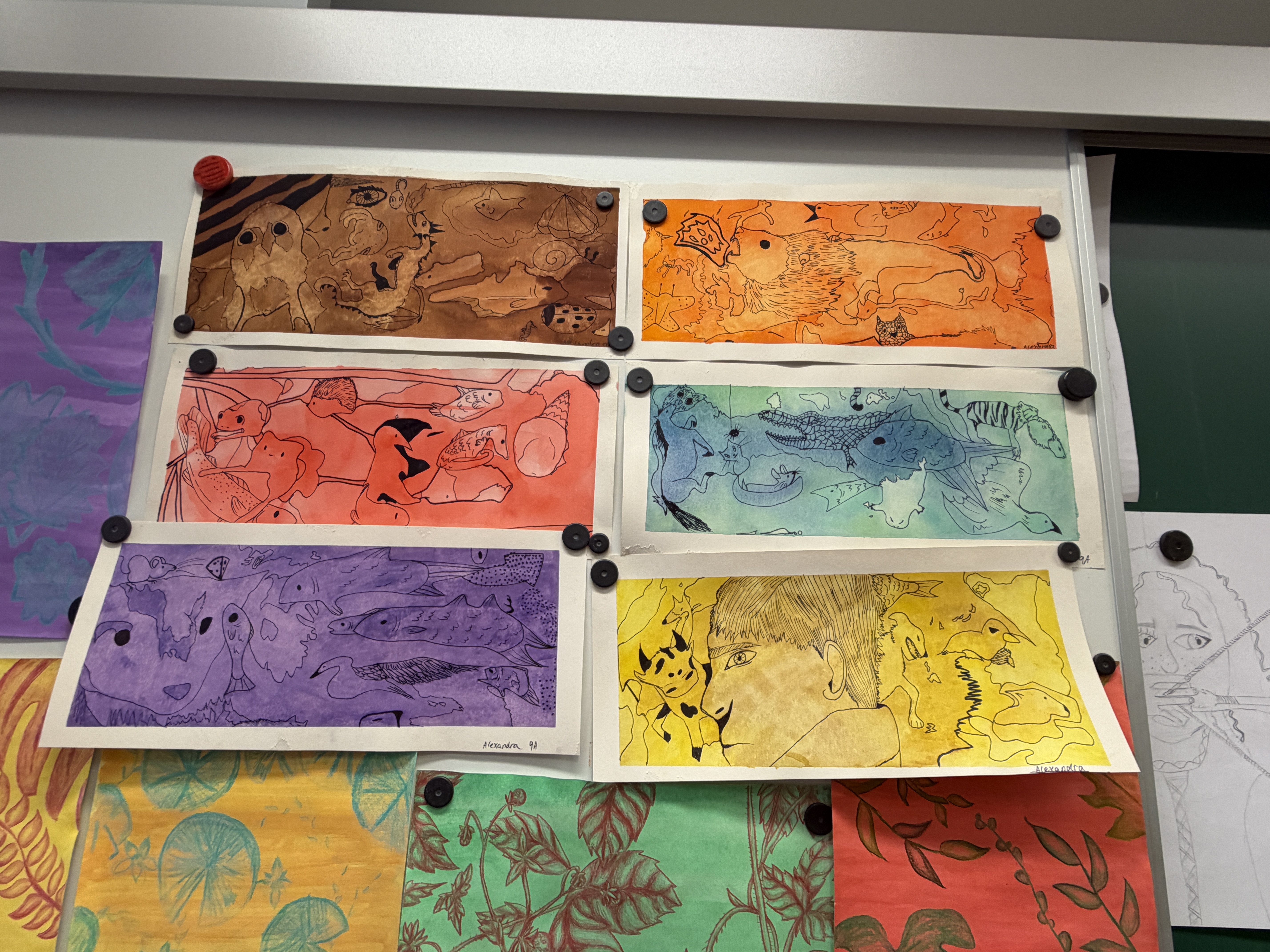 Display of several colorful Watercolor flows school paintings